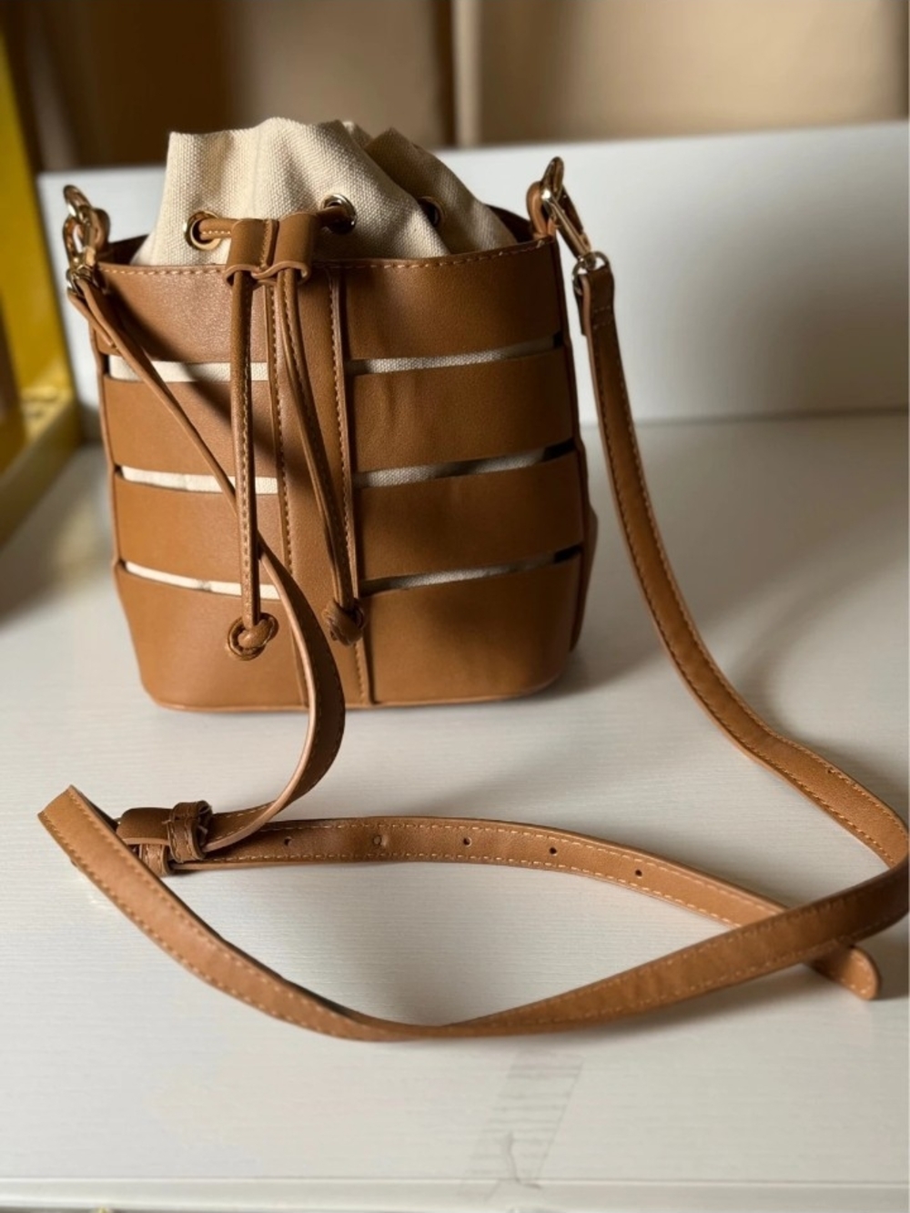 Madison West Tan Bucket Crossbody Bag with Drawstring Closure